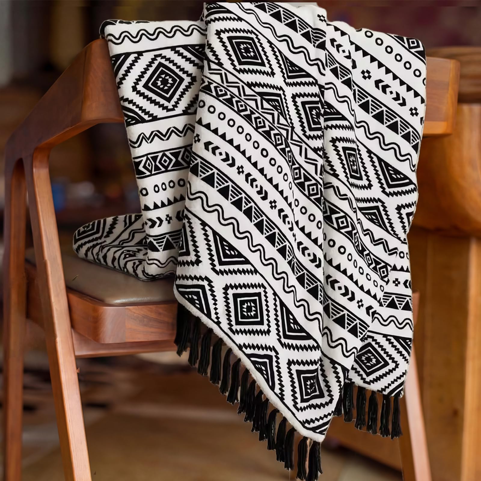 CASAAGUSTO bohemian cozy blanket shown on bed for all-season warmth.