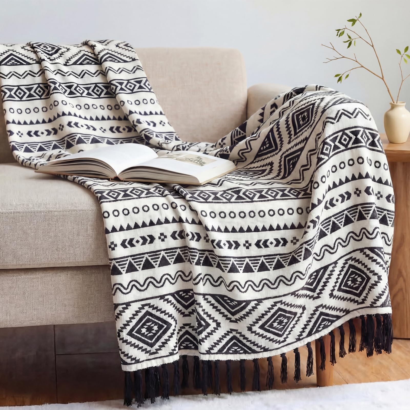 CASAAGUSTO boho throw blanket on a couch; tassels add texture and style.