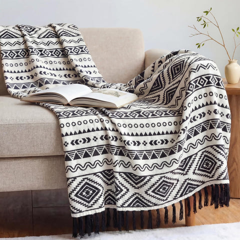 CASAAGUSTO boho throw blanket on a couch; tassels add texture and style.