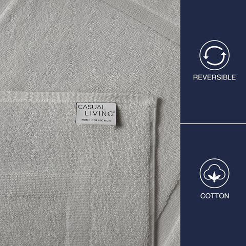 Casual Living grey cotton bath mat by sink, absorbs water and dries quickly.