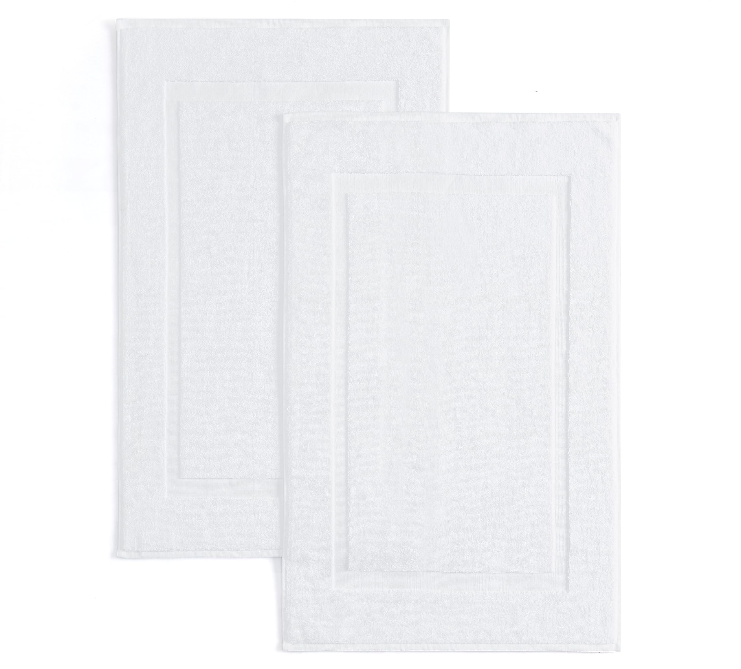 Casual Living white cotton bath mat 34x21 inches near shower for soft, absorbent comfort.