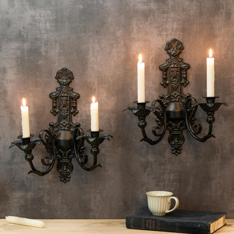 CC Wonderland Zone candle sconce set on wall with black iron finish for ambient lighting.
