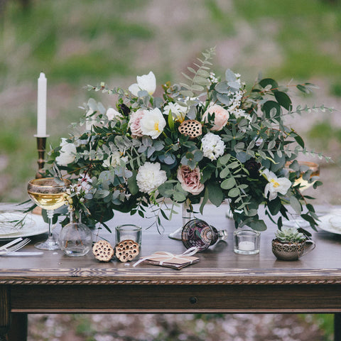 CEWOR eucalyptus stems used in a wedding centerpiece setup