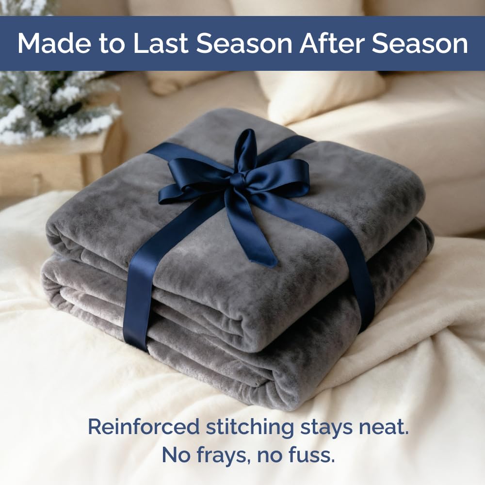 CGK Unlimited dark grey fleece blanket in a living room setting.