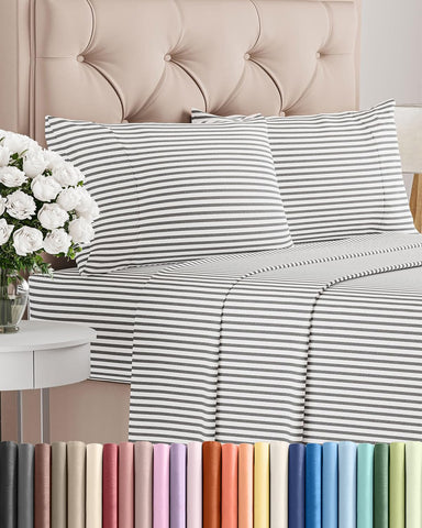 CGK Unlimited full-size sheet set with grey stripes on bed for premium comfort