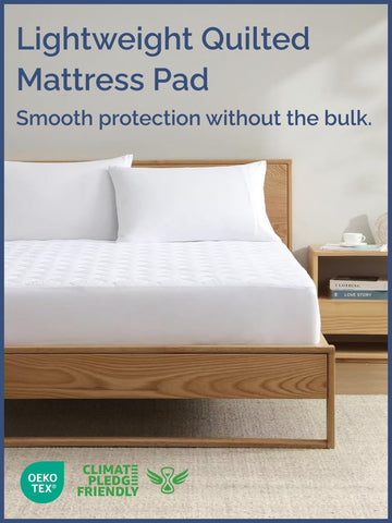 CGK Unlimited quilted fitted mattress pad elastic wraparound fit secured to a queen bed