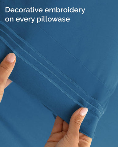 CGK Unlimited denim blue bed sheets in a cozy bedroom setup