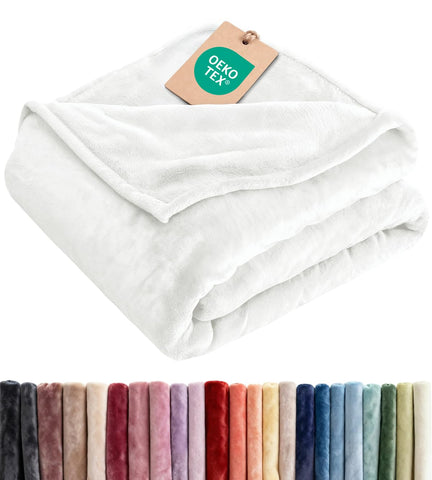 CGK Unlimited ultra-soft fleece blanket on a queen bed for year-round comfort
