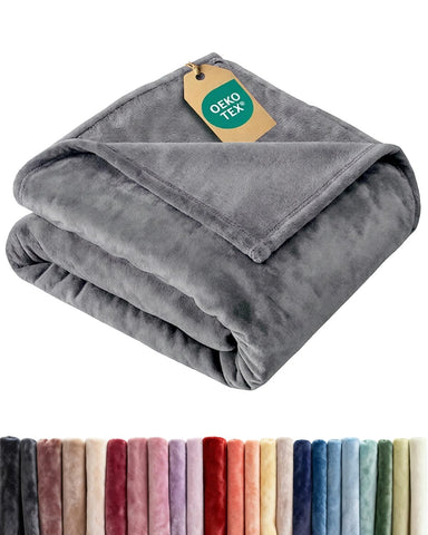 CGK Unlimited ultra-soft fleece blanket on couch for cozy lounging.