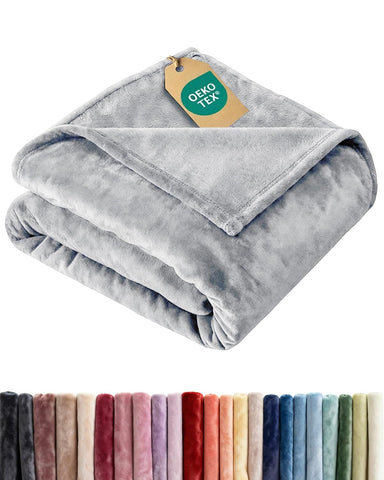 CGK Unlimited ultra-soft fleece blanket on bed delivering luxurious warmth