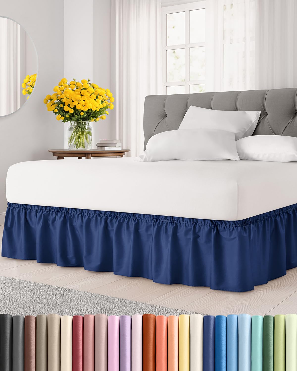 CGK Unlimited navy wrap-around dust ruffle on a queen bed, with a 12-inch drop.