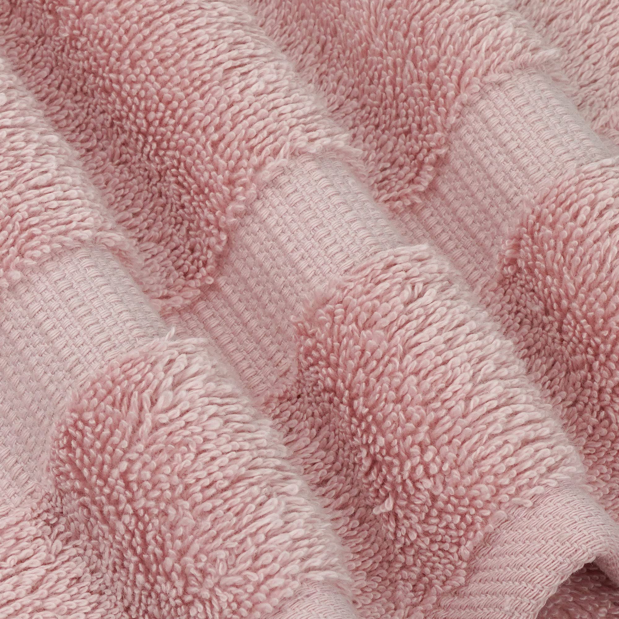 Chakir Turkish Linens spa-like softness on a neatly folded pink towel.