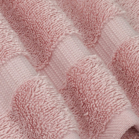 Chakir Turkish Linens spa-like softness on a neatly folded pink towel.
