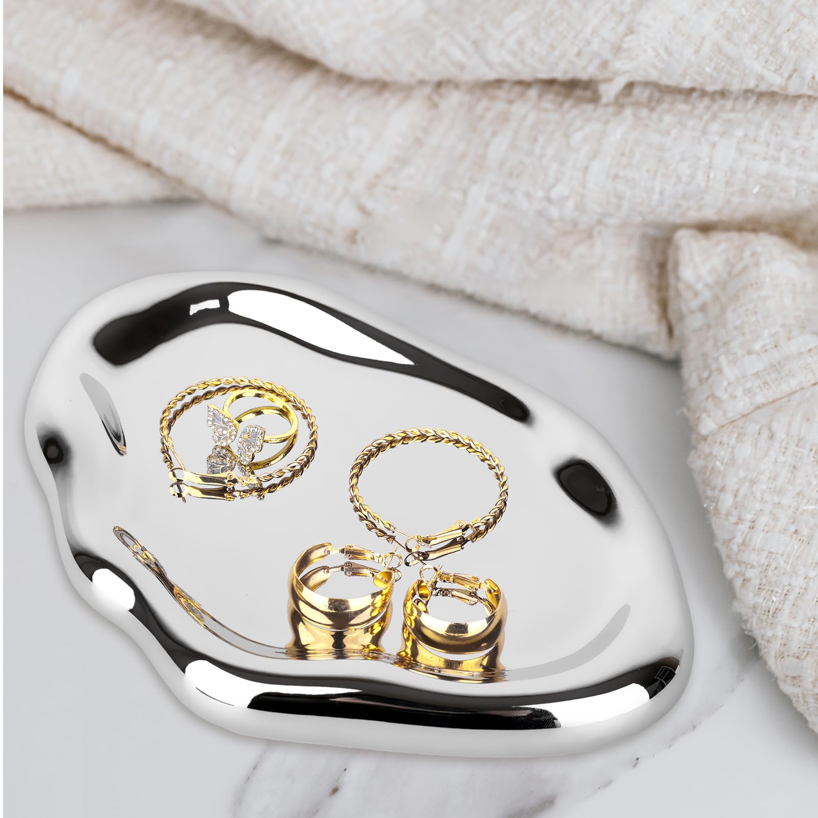 Chendecor silver tray dresser top demonstrates cosmetics and jewelry neatly arranged.