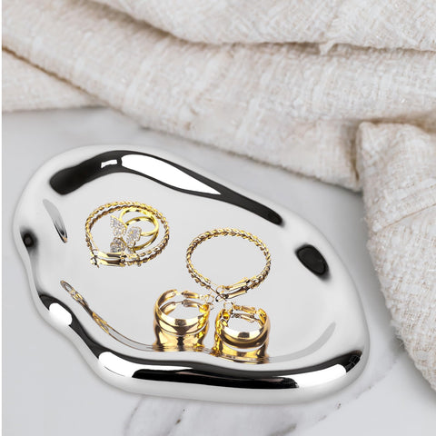 Chendecor silver tray dresser top demonstrates cosmetics and jewelry neatly arranged.