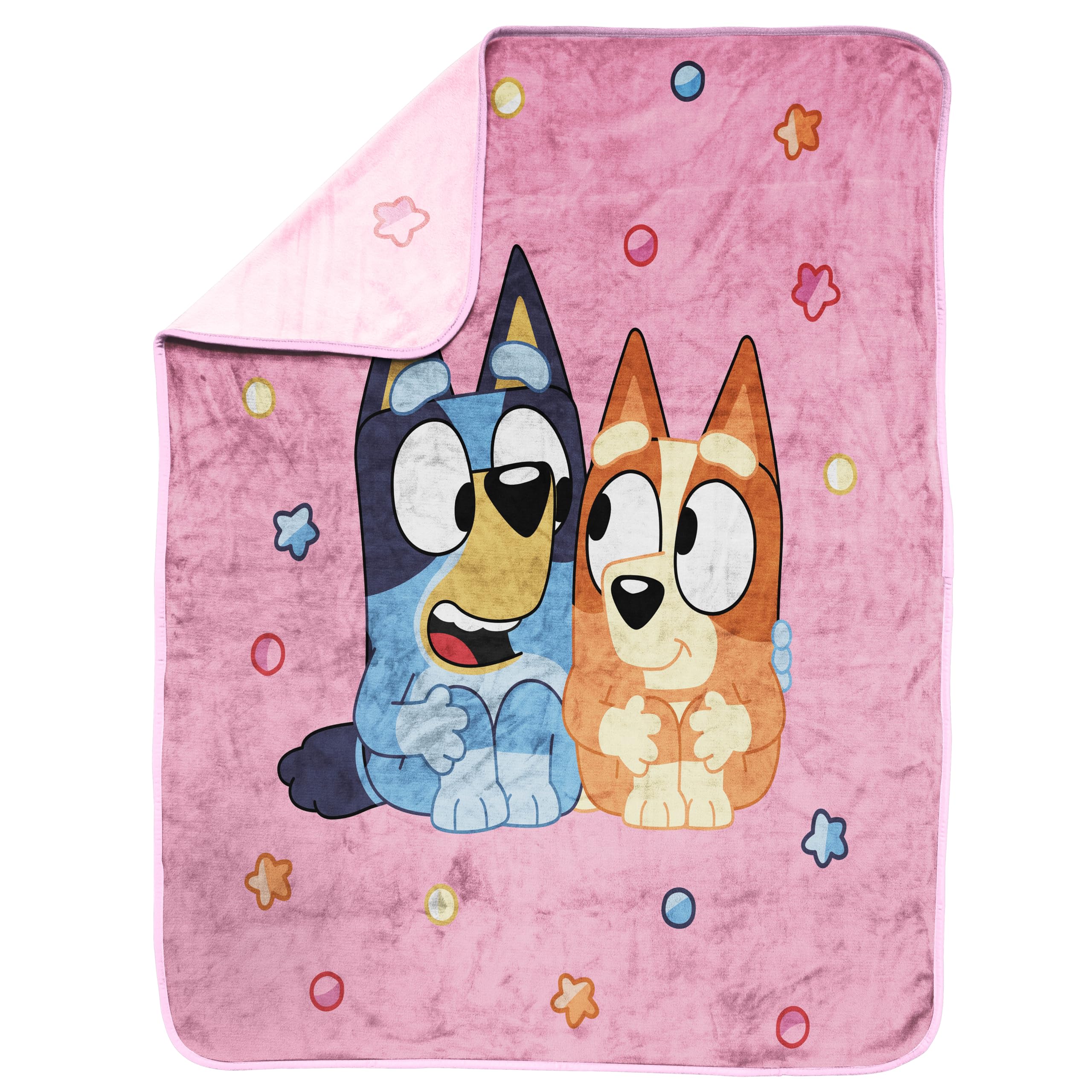 Child cuddling on bed with the throw, showing versatile use