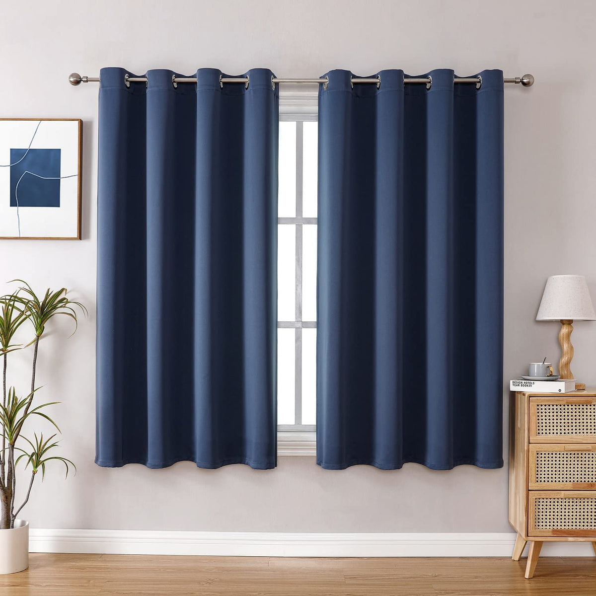 ChrisDowa grommet blackout curtains in stone blue for a two-panel bedroom setup.