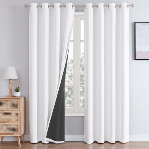 ChrisDowa white blackout curtains with grommet-top design block light for restful sleep.