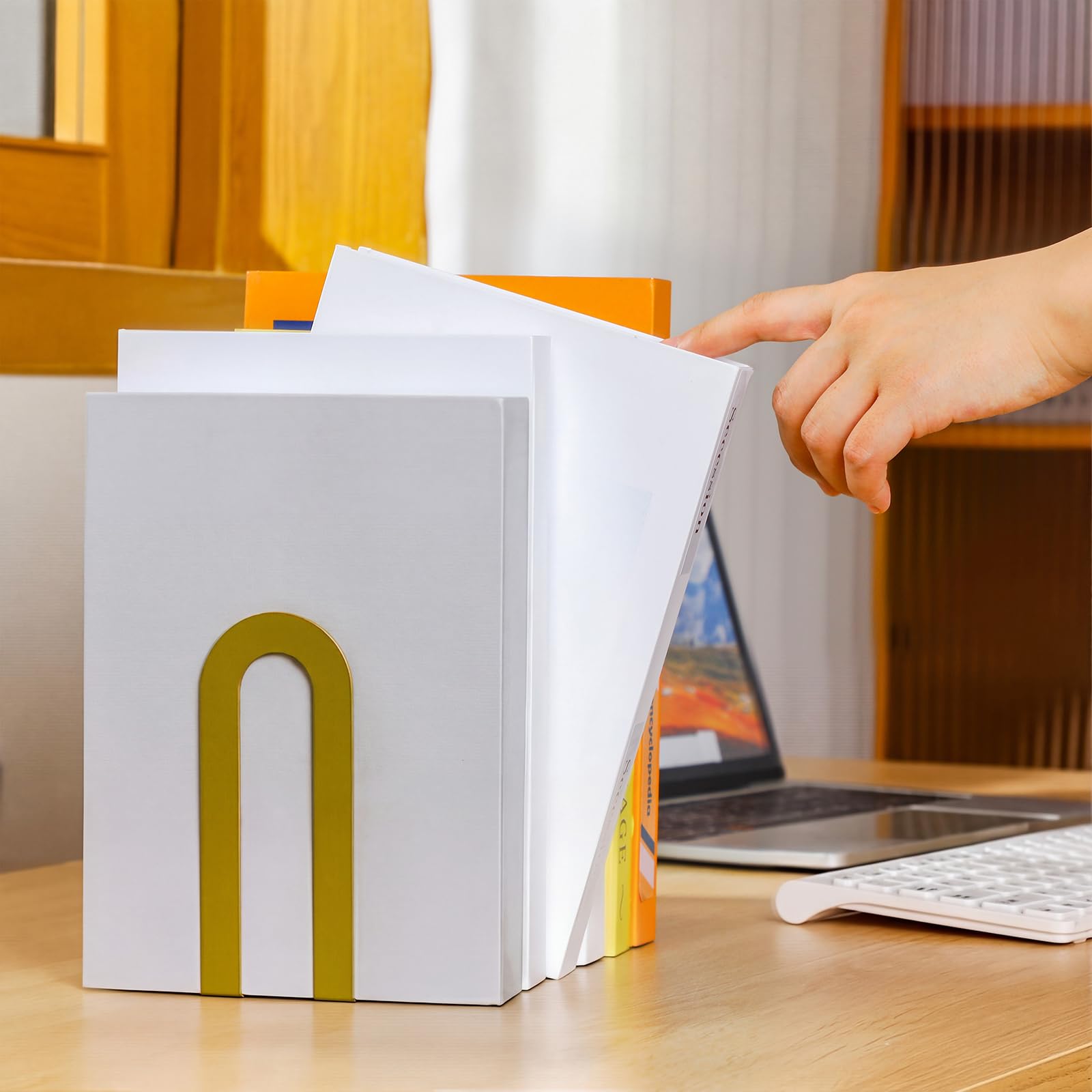 Chunful gold book ends open-arm design showcases book covers elegantly.