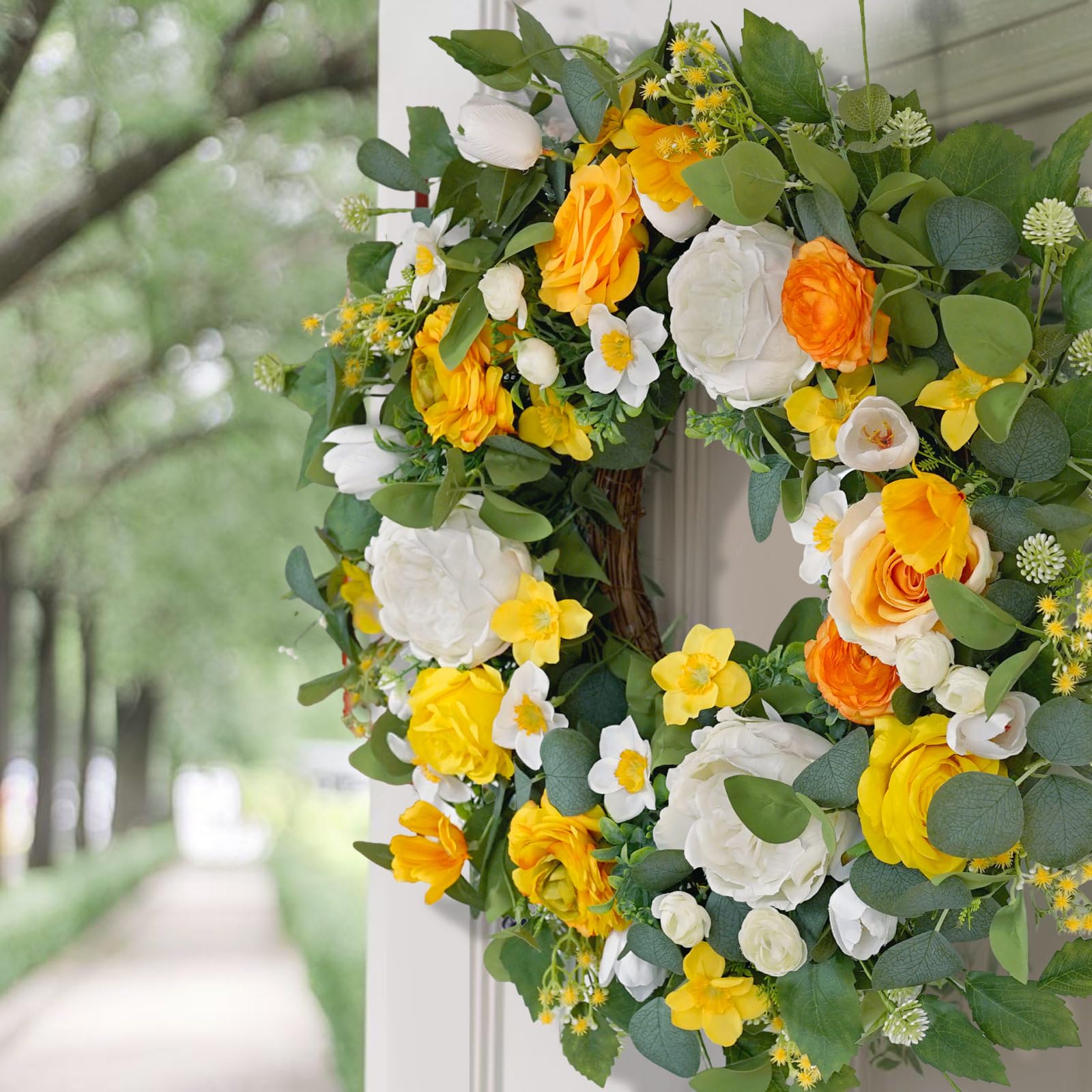 Daffodils and blossoms in CHvista wreath for seasonal charm.