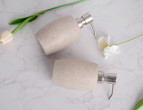 Two beige dispensers set blends with modern bathroom and kitchen decor.