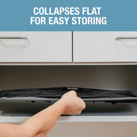 CleverMade black collapsible laundry basket carried to the laundry room