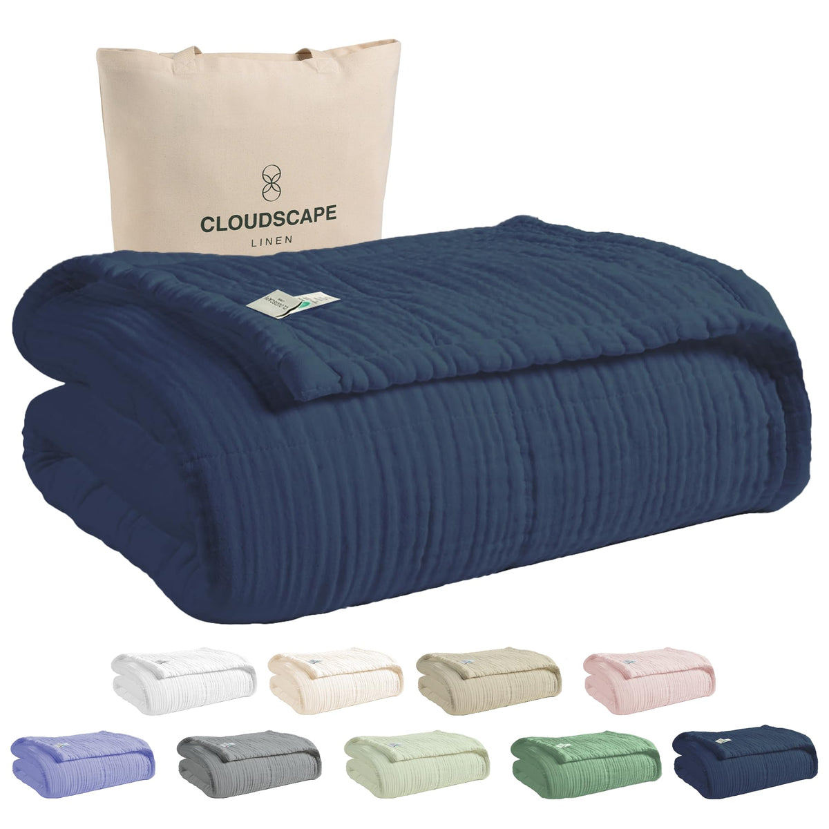Cloudscape Linen 8-layer muslin blanket on a bed demonstrates oversized king coverage and all-season warmth.