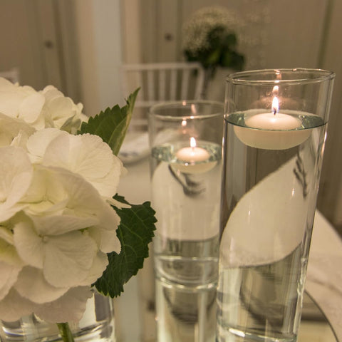 CLTNIKET white floating candle enhances vase centerpiece decor.