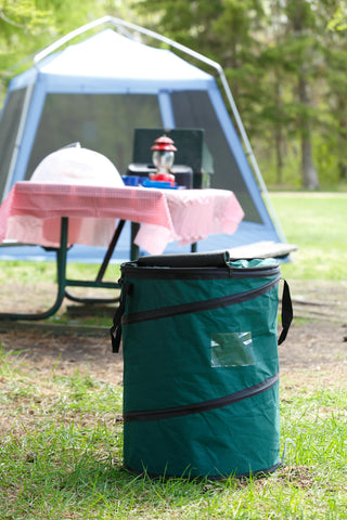 Coghlan's pop-up trash bin at campsite organizes waste and recyclables efficiently.
