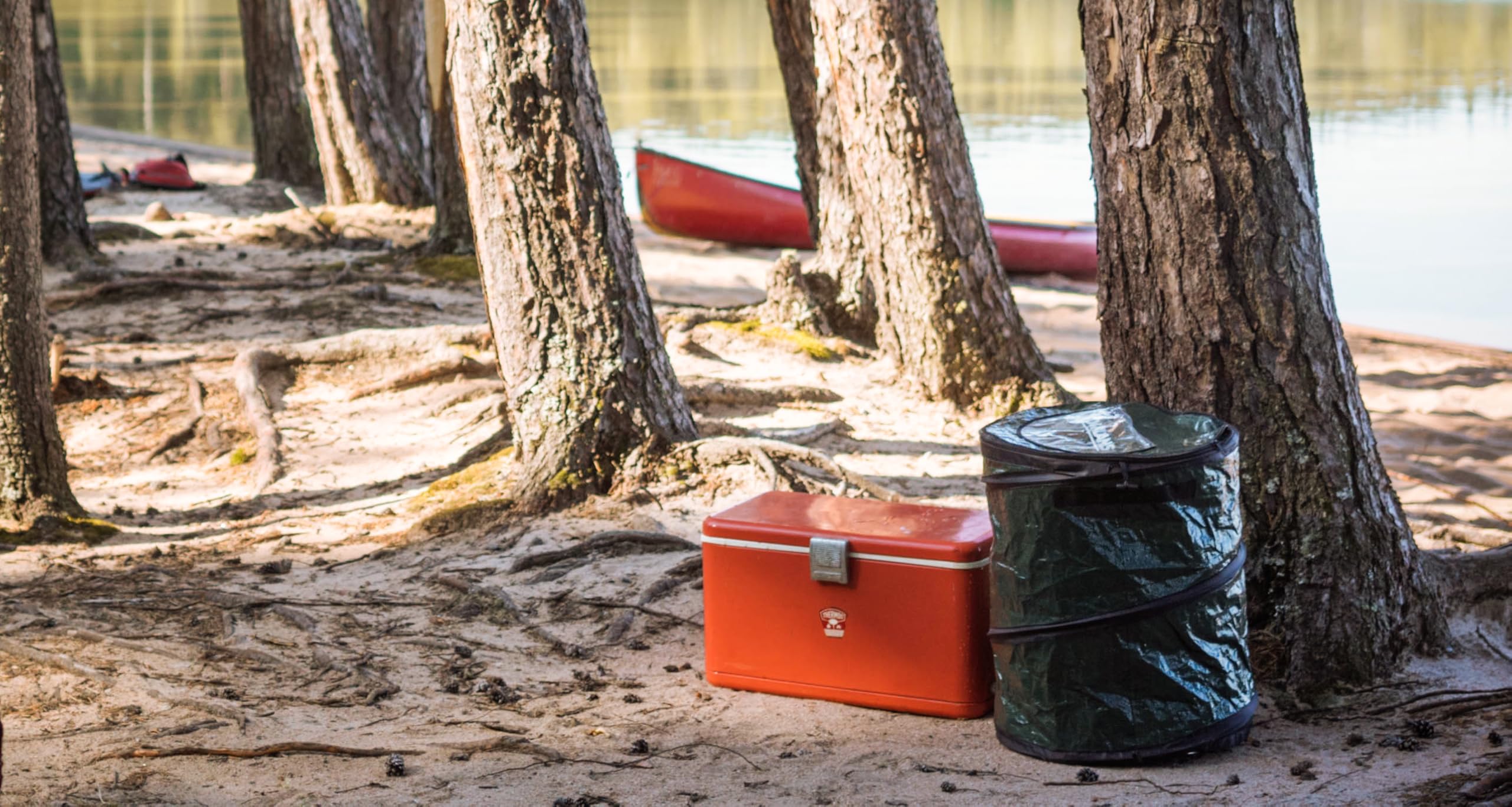 Coghlan's pop-up trash bin built-in handles simplify transport during trips.