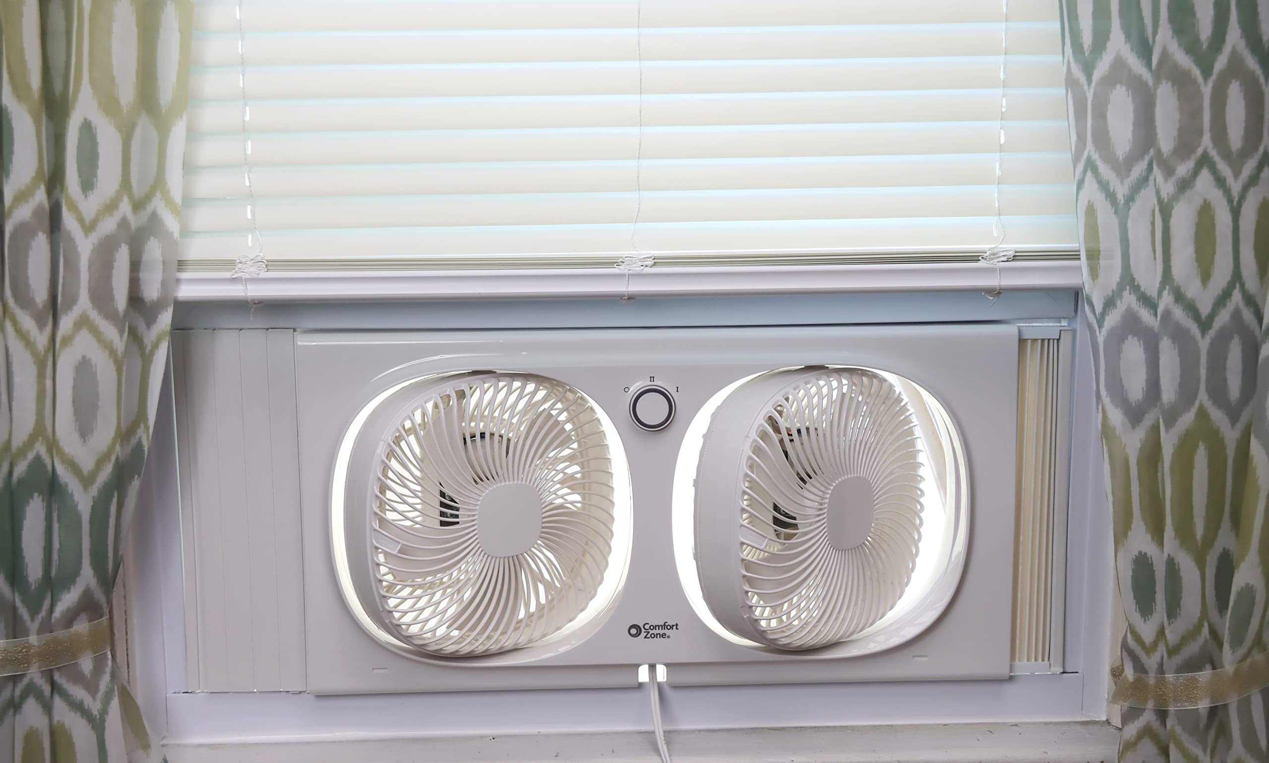 Comfort Zone 9-Inch window fan with 180-degree rotating heads for directional air.