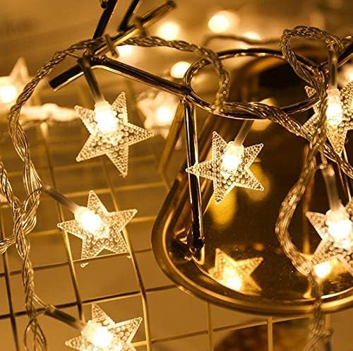 Comtelek 100 LED star lights create a warm bedside glow.
