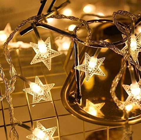 Comtelek 100 LED star lights create a warm bedside glow.