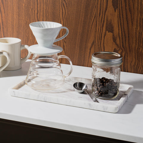Cork & Mill marble tray on the toilet tank area consolidates essentials.