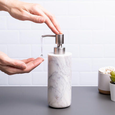 Cork & Mill marble dispenser close-up shows brushed stainless pump for durable use.