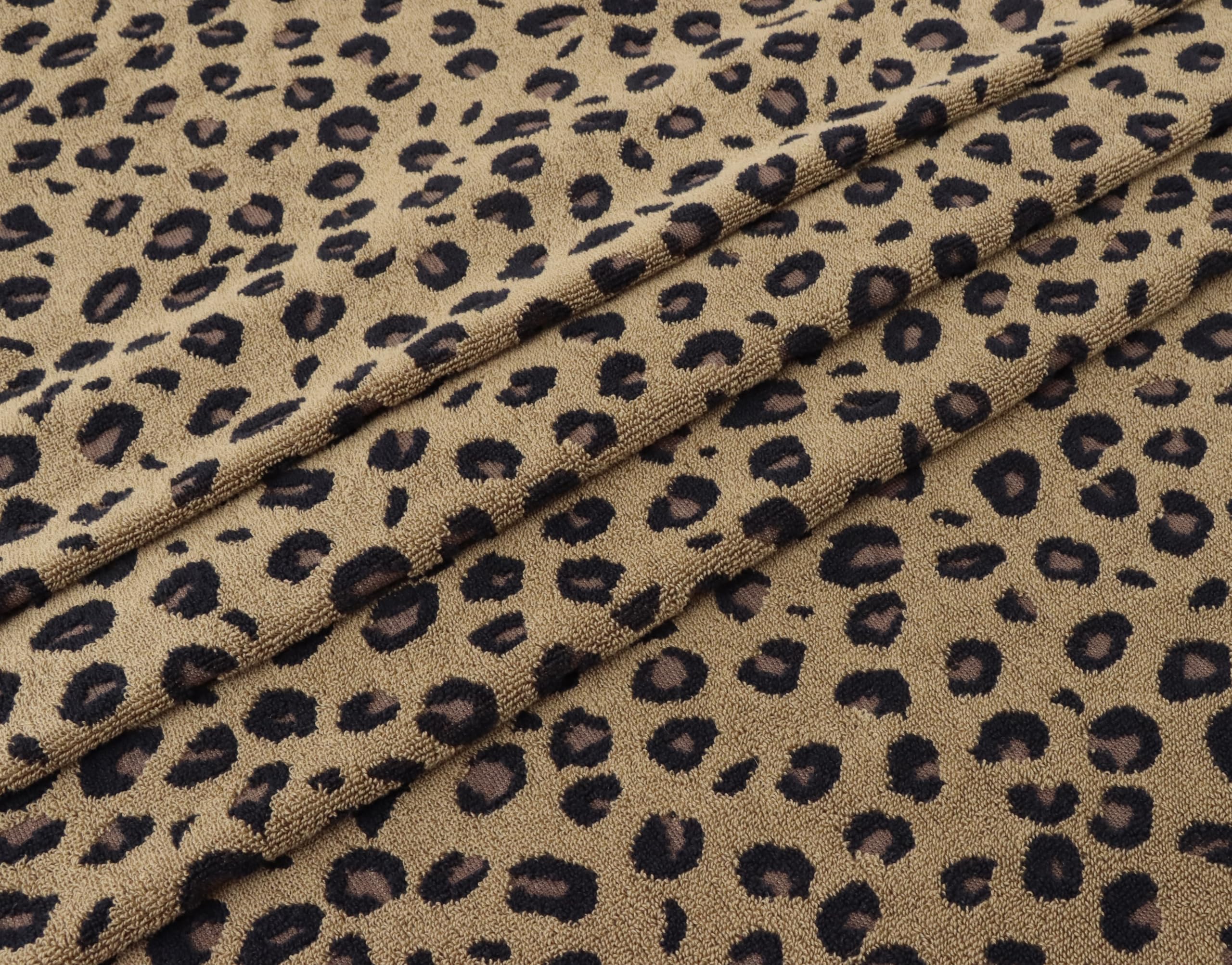 Leopard-print design on a COTTON CRAFT bath towel adds decor appeal.
