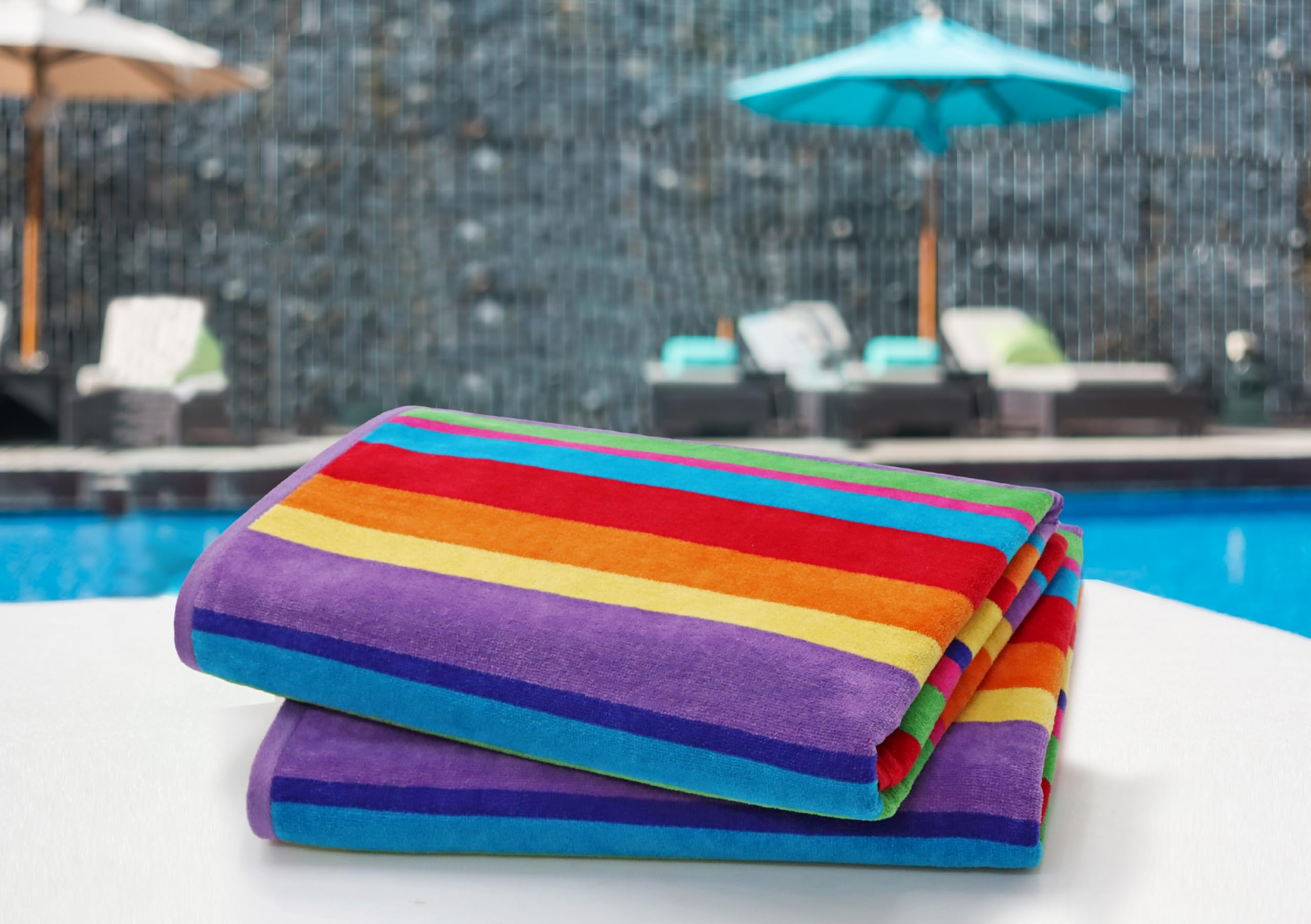 Cotton Craft Summer of Siam multistripe towel on a chair highlights vibrant color durability.