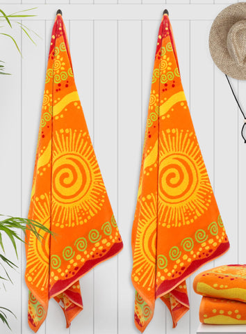 Cotton Craft sunshine orange towel on sand for bright vacation vibes.
