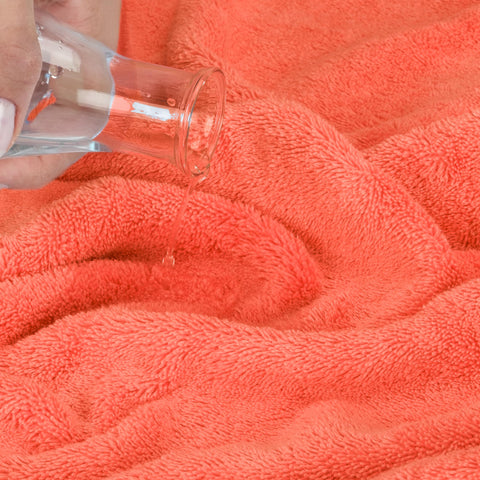 Cotton Paradise coral towel stitching detail emphasizes durability and long-lasting use.