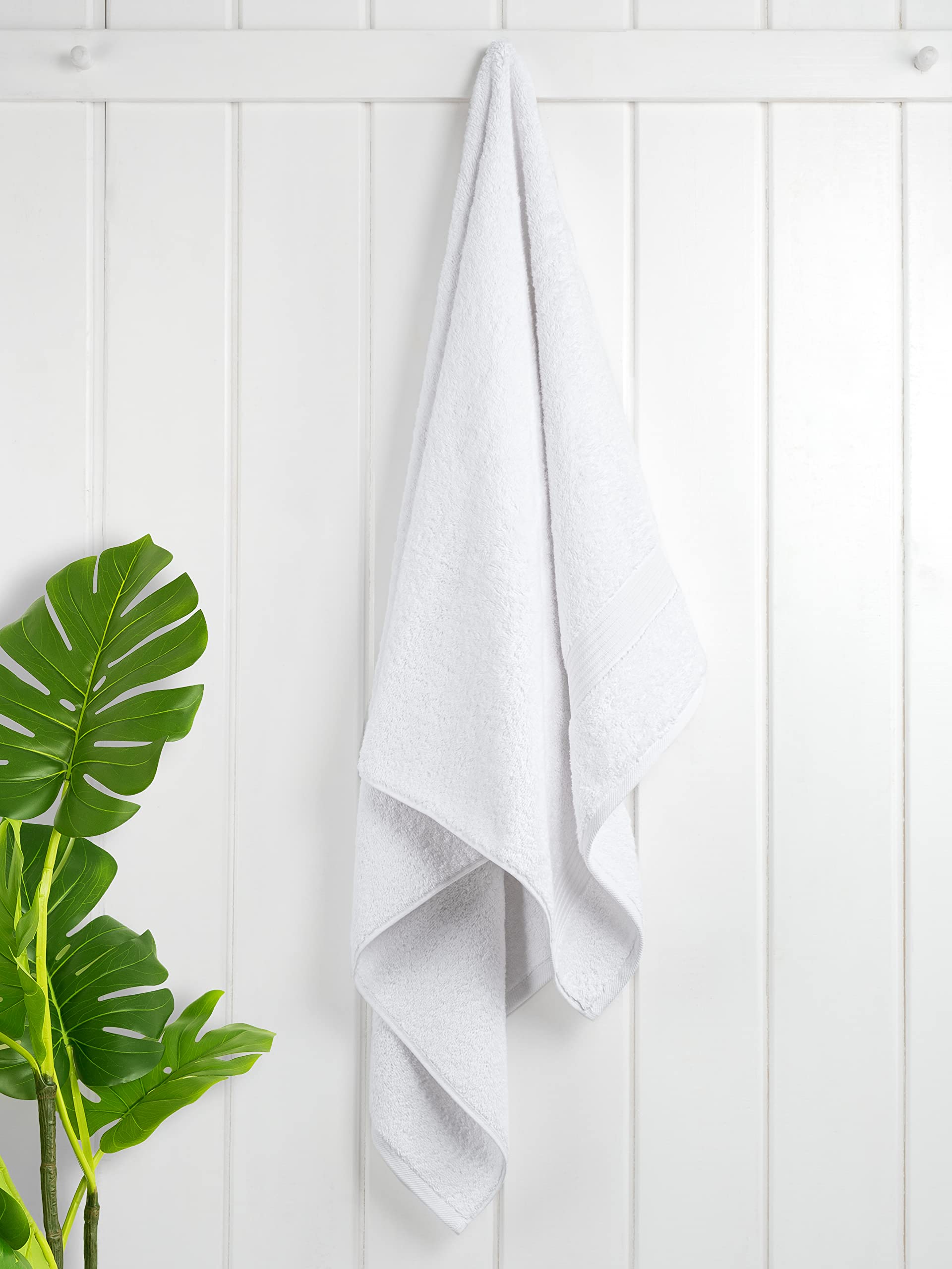 Cotton Paradise towels set on bathroom counter ready for guest use.