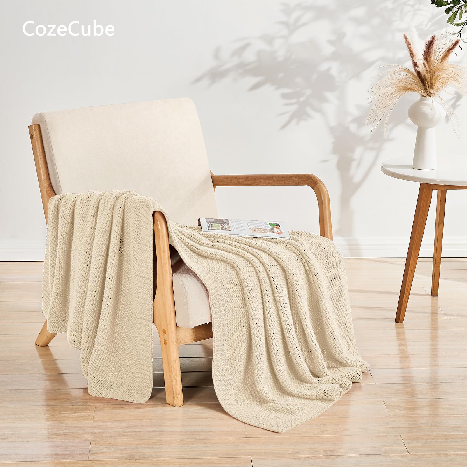 CozeCube beige throw elegantly draped on bed for a relaxed bedroom vibe.