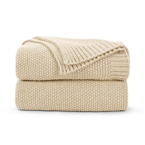 CozeCube beige throw on couch offering cozy warmth for living room evenings.
