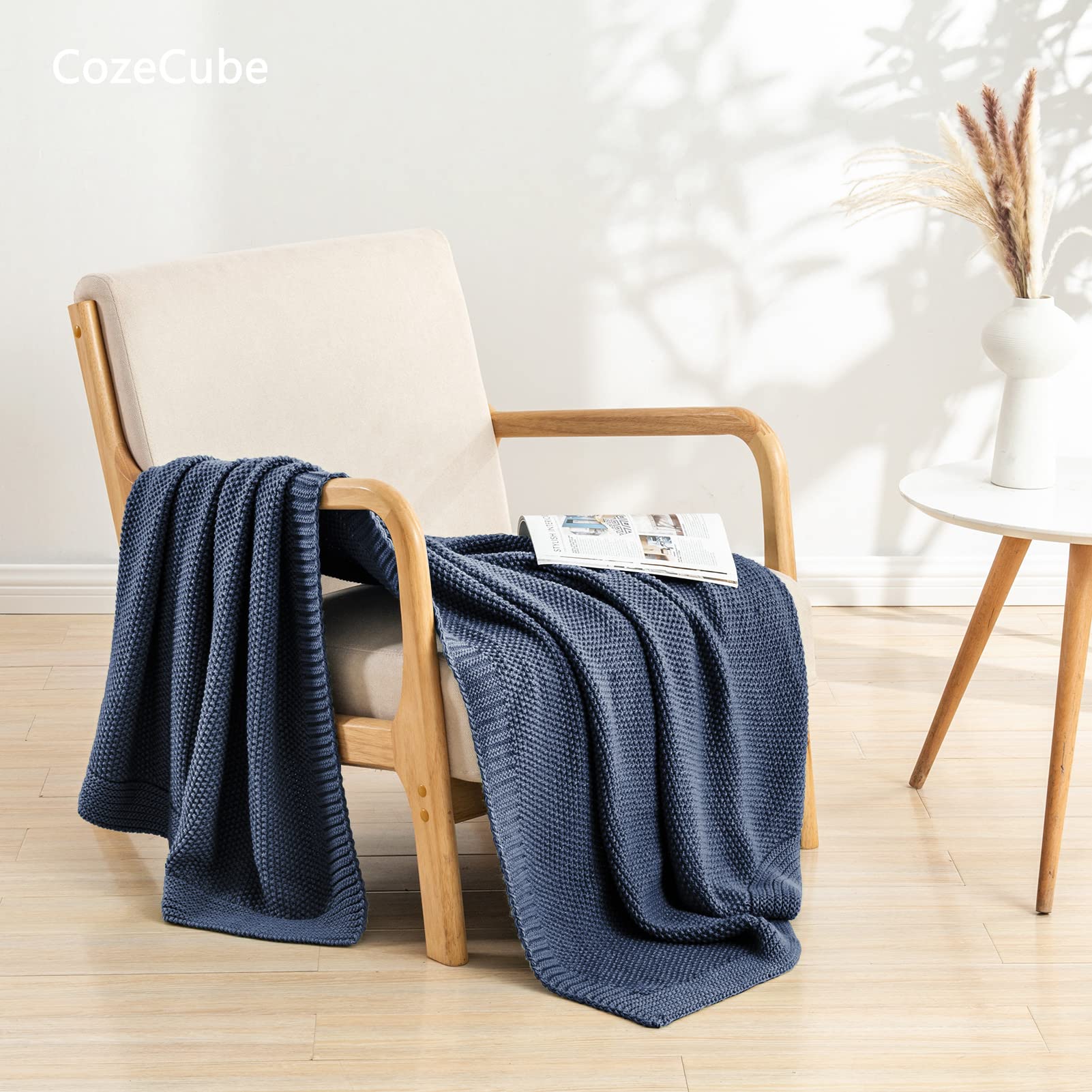 CozeCube Blue knit throw placed on a bed for a warm, inviting bedroom look