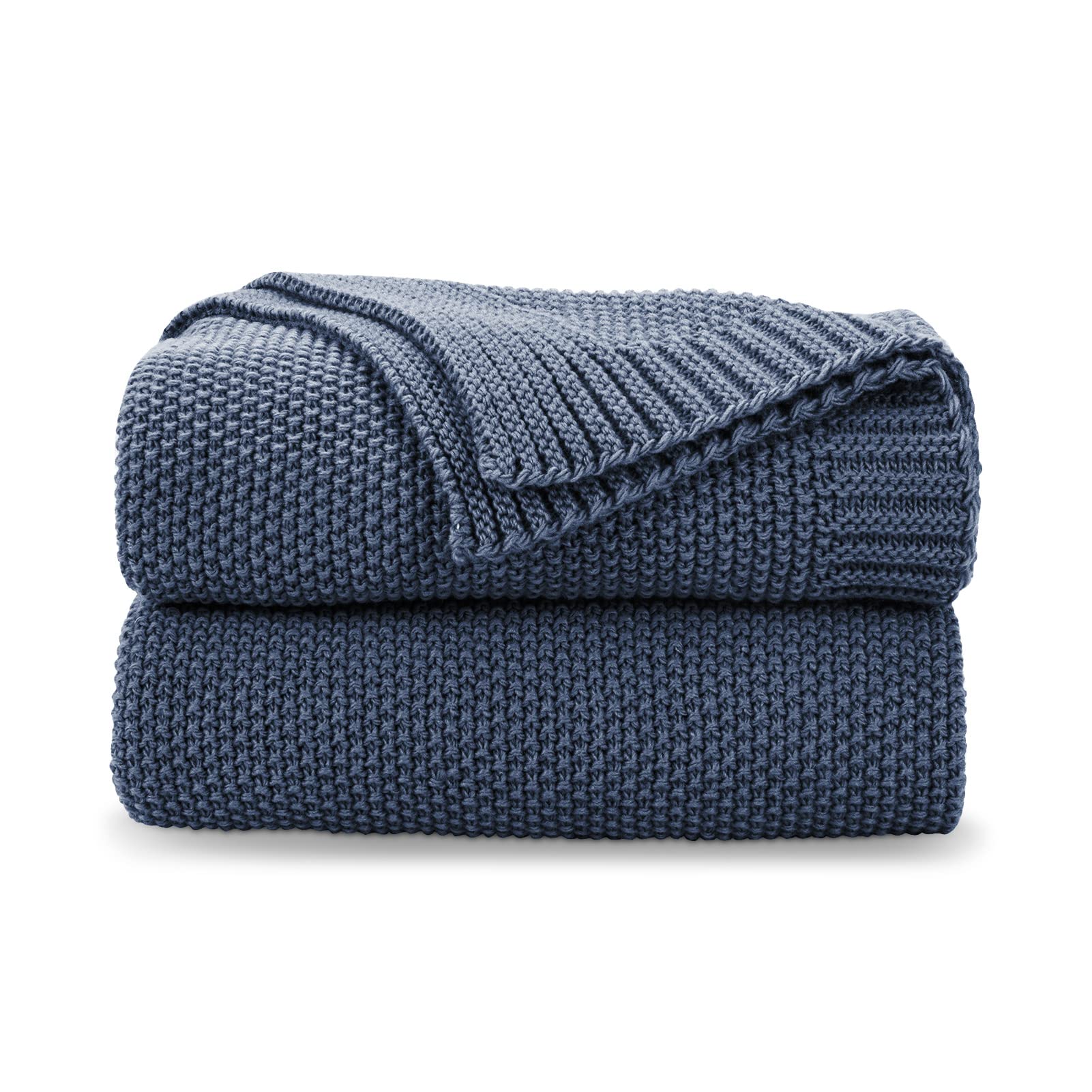 CozeCube Blue knit throw draped over a couch for cozy living room warmth