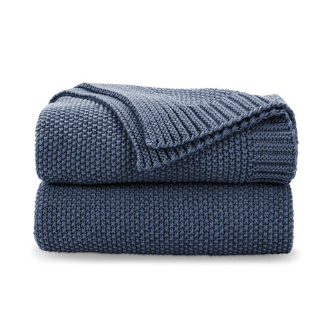 CozeCube Blue knit throw draped over a couch for cozy living room warmth
