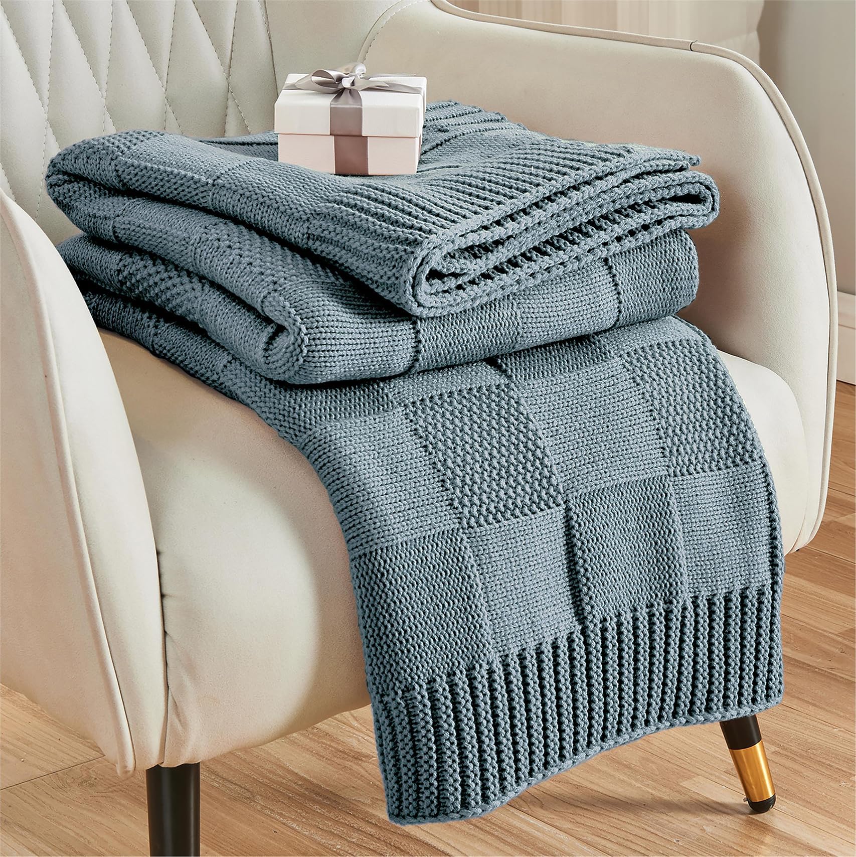 CozeCube dusty blue check knit throw drapes softly over a sofa for cozy evenings.