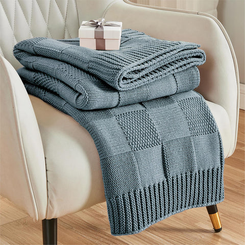 CozeCube dusty blue check knit throw drapes softly over a sofa for cozy evenings.