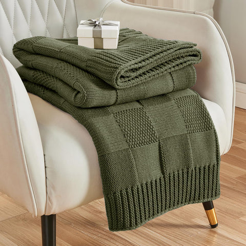 CozeCube olive check knit throw draped over a living room couch for warmth