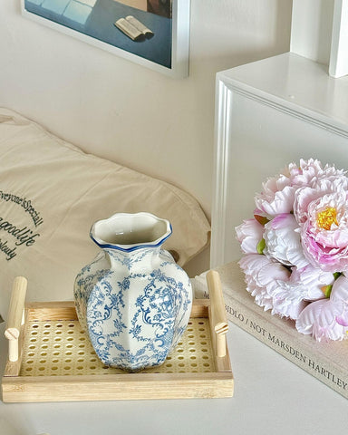 COZLIV Vintage Blue Ceramic Vase with flowers evokes timeless elegance.