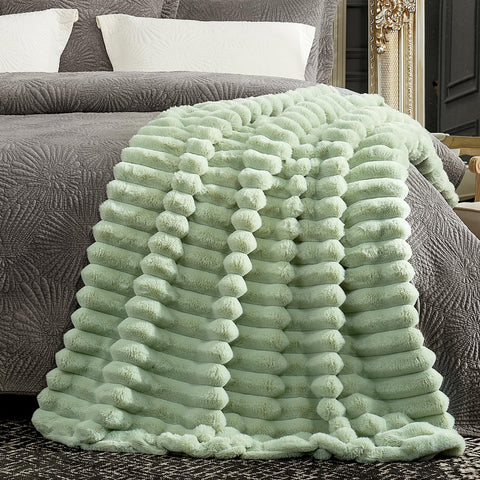 Cozy Bliss faux fur throw blanket folded on display creates a plush accent.
